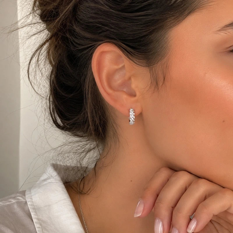 Woman wearing elegant Moissanite Hoop Earrings crafted in genuine 925 sterling silver with brilliant sparkling stones.