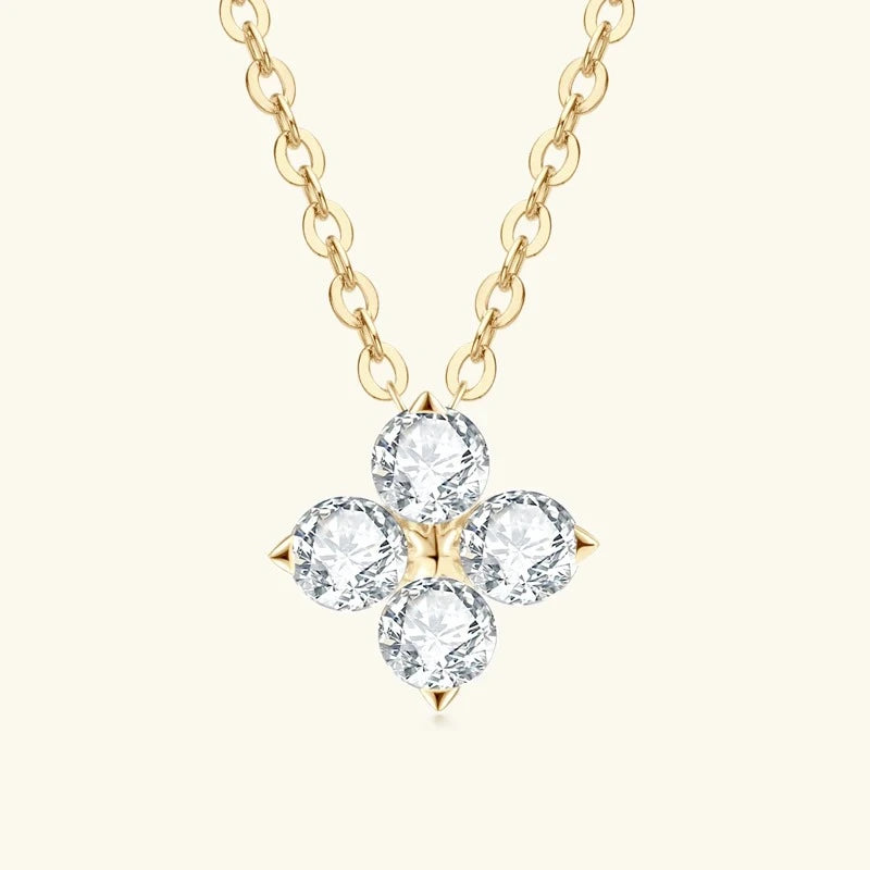 Gold four leaf clover pendant necklace with brilliant moissanite stones in a timeless minimalist design