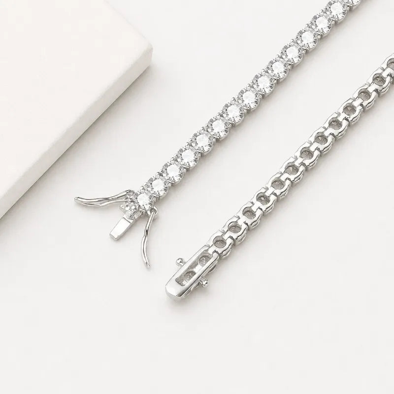Open clasp detail of a sterling silver moissanite tennis bracelet.