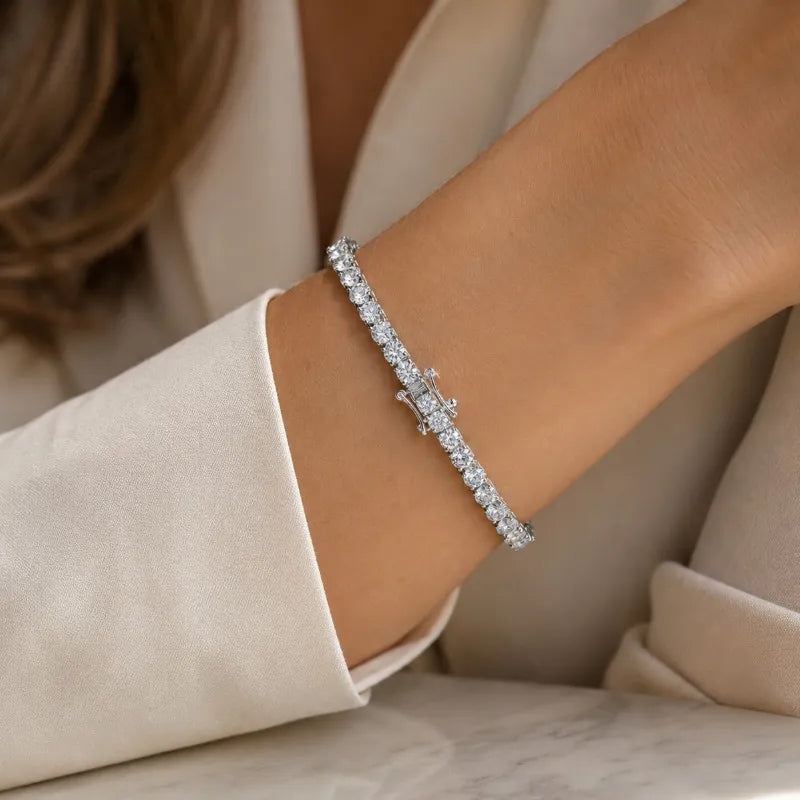 Woman wearing a sterling silver moissanite tennis bracelet with a sophisticated look.