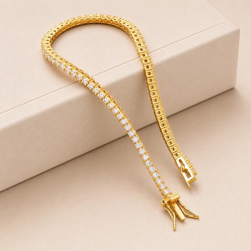 Gold-tone moissanite tennis bracelet displayed on a premium jewellery box.