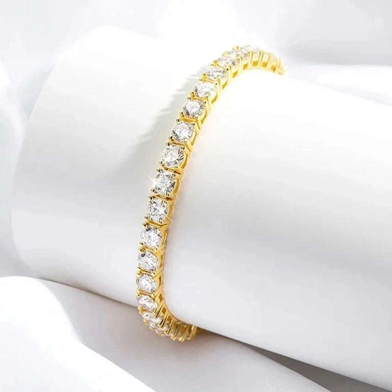 Gold-tone moissanite tennis bracelet for women displayed on soft white fabric.