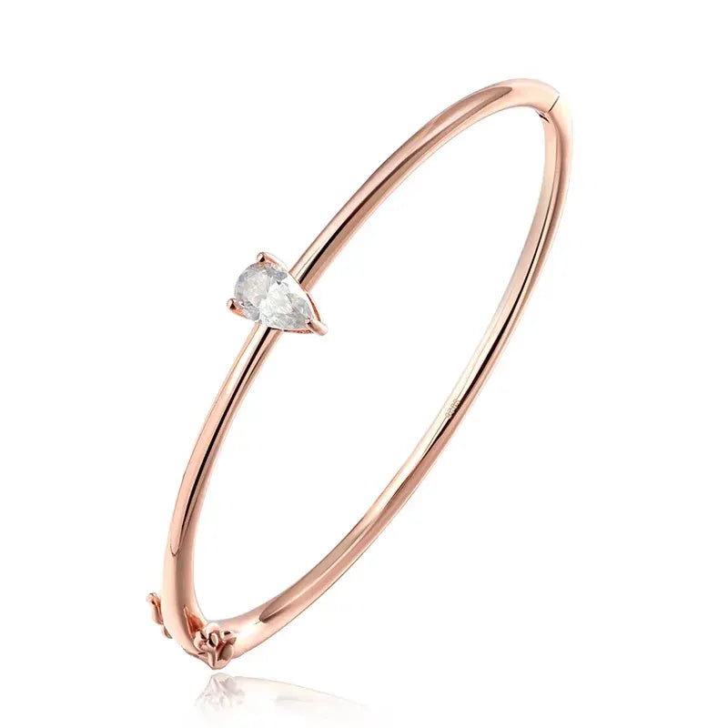 Céleste rose gold-tone sterling silver bangle featuring a 1 carat pear-cut moissanite