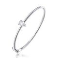 Detailed close-up of a brilliant pear-cut moissanite set in a slender sterling silver bangle