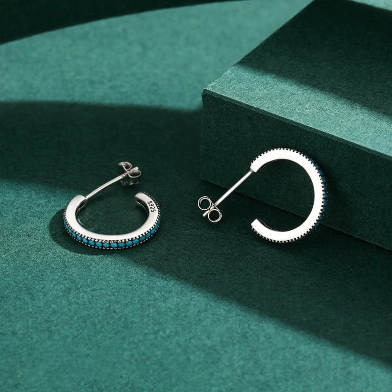 Close-up of Round Vintage Stud Earrings featuring natural turquoise stones set in genuine 925 sterling silver.