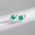 Close-up of round turquoise stud earrings showing the polished bezel setting and 925 sterling silver finish