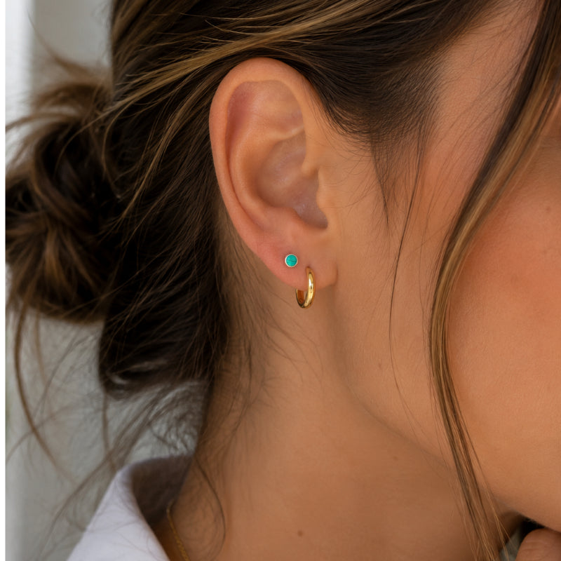 Woman wearing Sterling Silver Turquoise Earrings with small round turquoise stones in a minimalist stud design